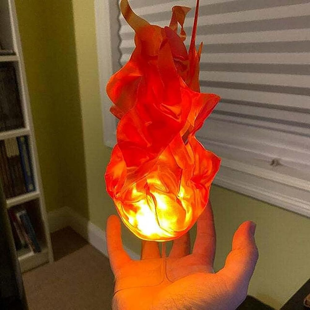Hand holding a glowing orange and red object against a room background