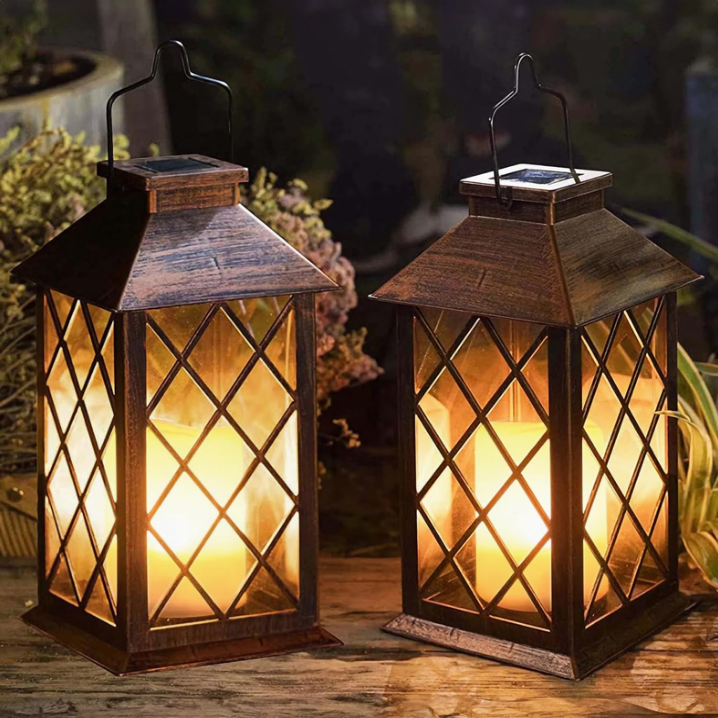 Two lit lanterns with solar panels on a wooden surface outdoors.