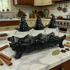 Decorative black witch hat jars on a marble countertop with kitchen background