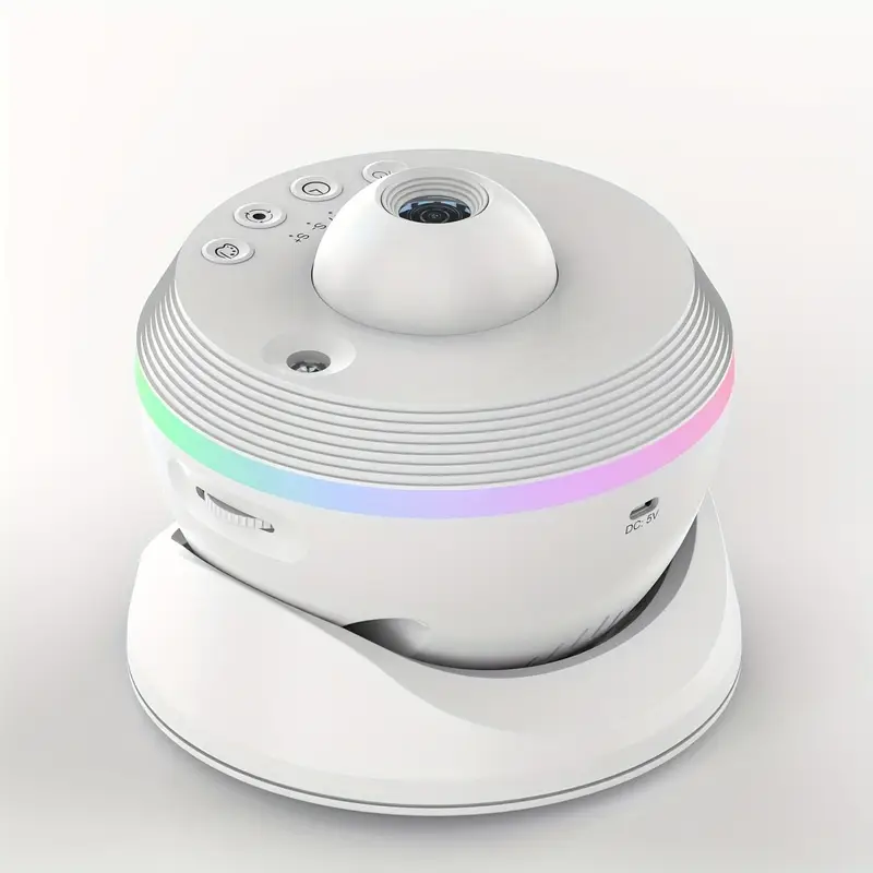 A white smart baby monitor camera with a matching white base dock, featuring a colorful LED light strip around the middle.