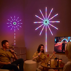 Two people sitting in a dimly lit room with colorful LED starburst wall lights glowing on the wall, one large multicolor light and one smaller purple light. A TV is on in the background, and the room has warm ambient lighting and party decor.