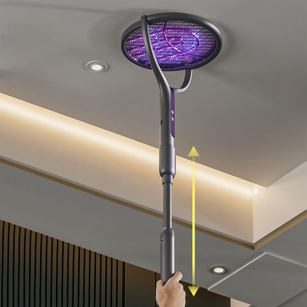 Hand holding a stick with a purple light fixture against a ceiling.