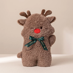A brown plush reindeer toy with small antlers, a red nose, and a dark green ribbon bow around its neck, photographed against a plain beige background.
