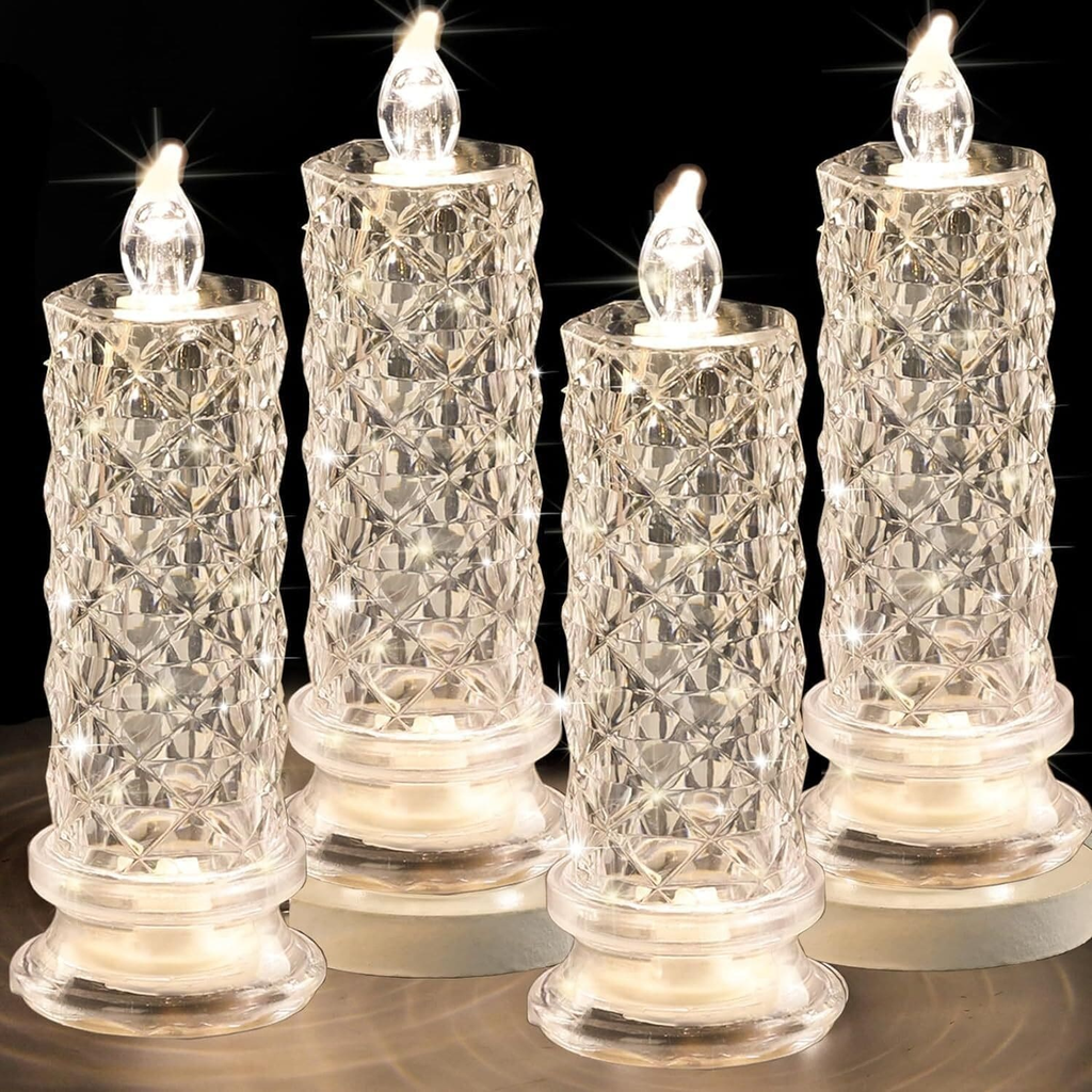 Set of four crystal-like candle lights on a reflective surface with a dark background