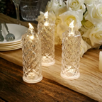 Decorative LED candles on a wooden table with flowers in the background