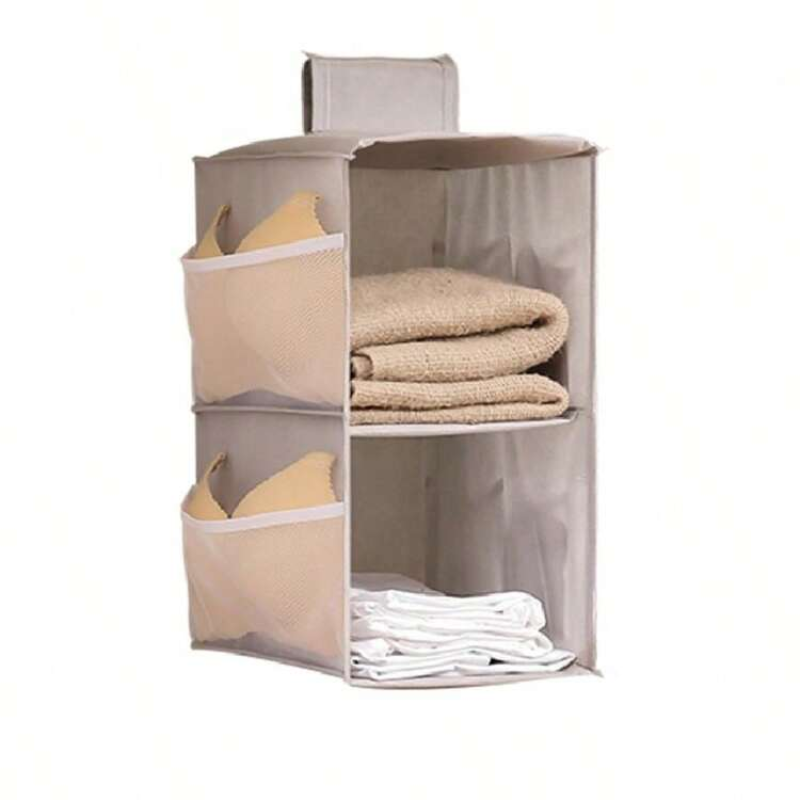 A fabric hanging organizer with three compartments, shown holding folded towels and bras against a plain white background.