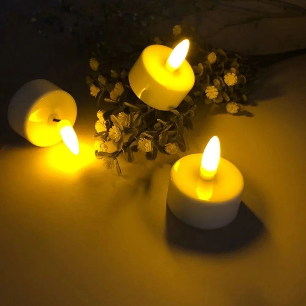 Three small yellow candles with white bases on a dark background