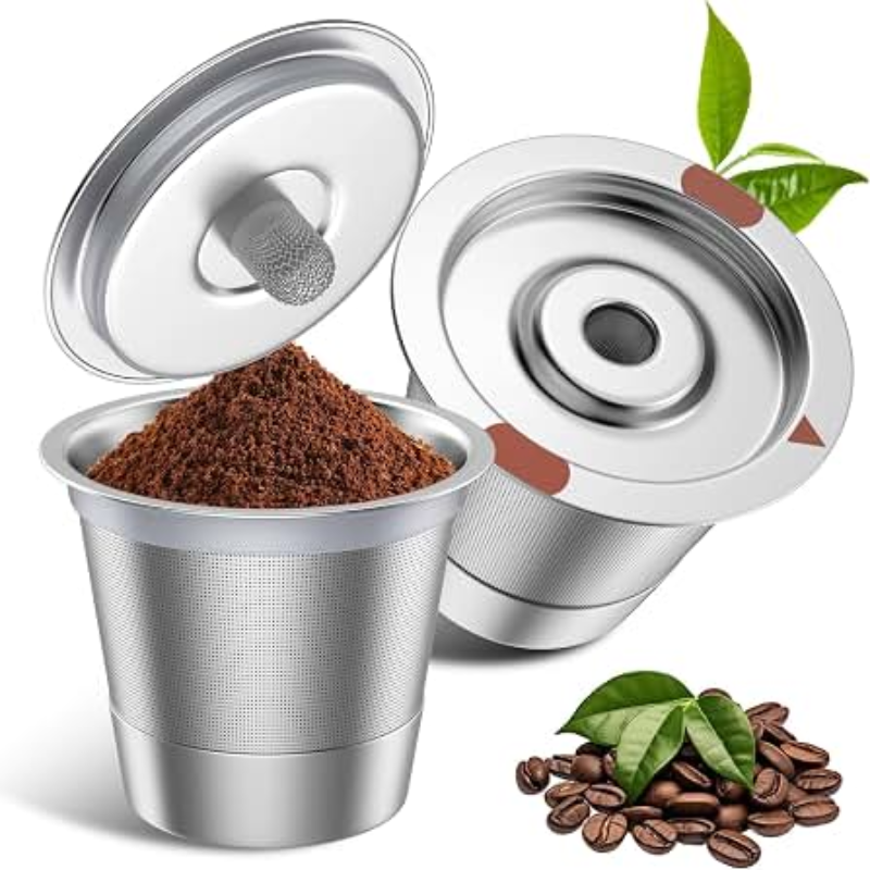 Stainless steel coffee filter with ground coffee and coffee beans on a white background