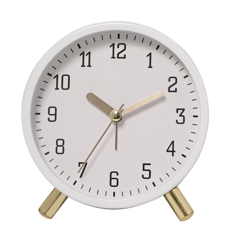White clock with gold accents on a white background