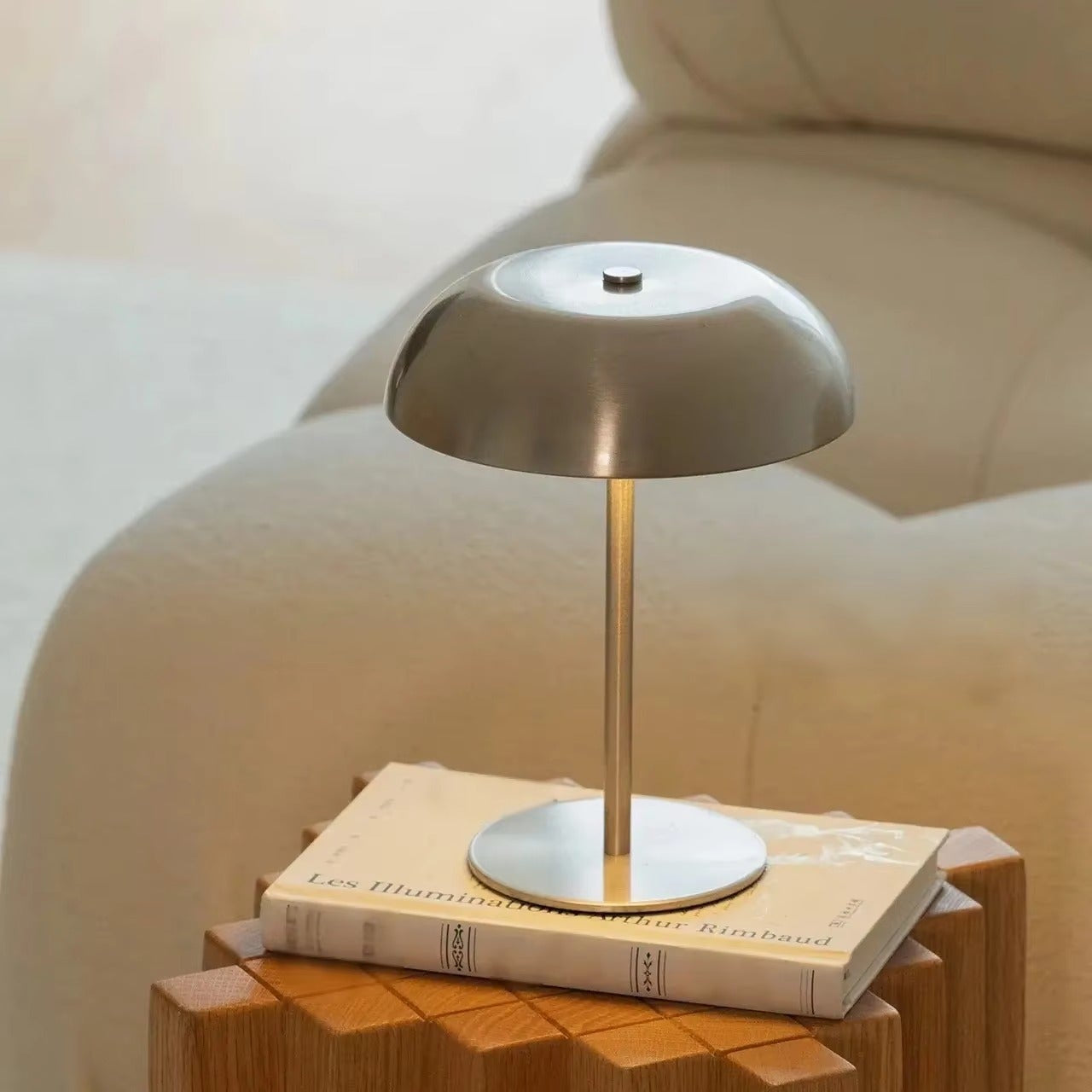 Table lamp on a wooden side table with a book underneath
