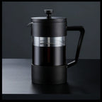 Black French press coffee maker on a dark background