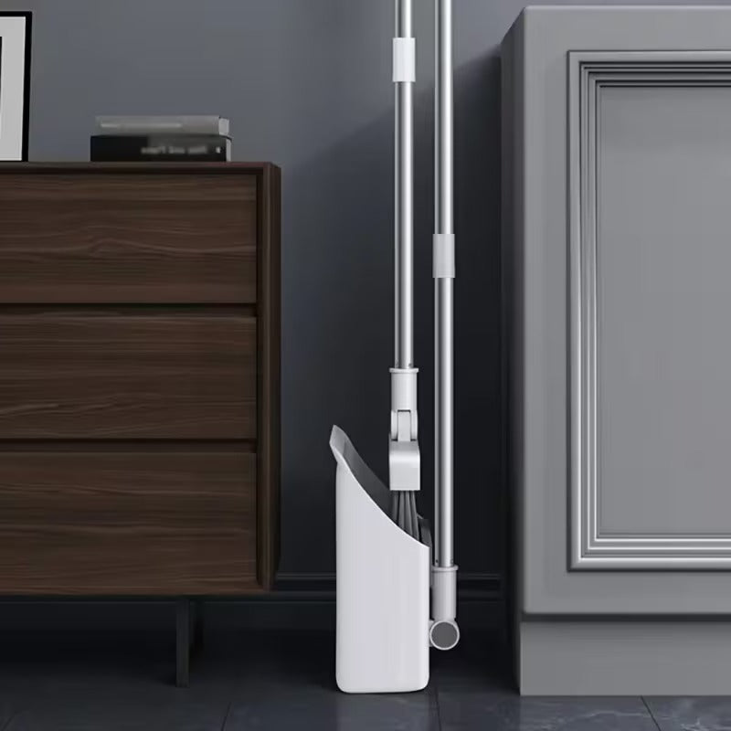 White vacuum cleaner against a gray wall with wooden furniture.