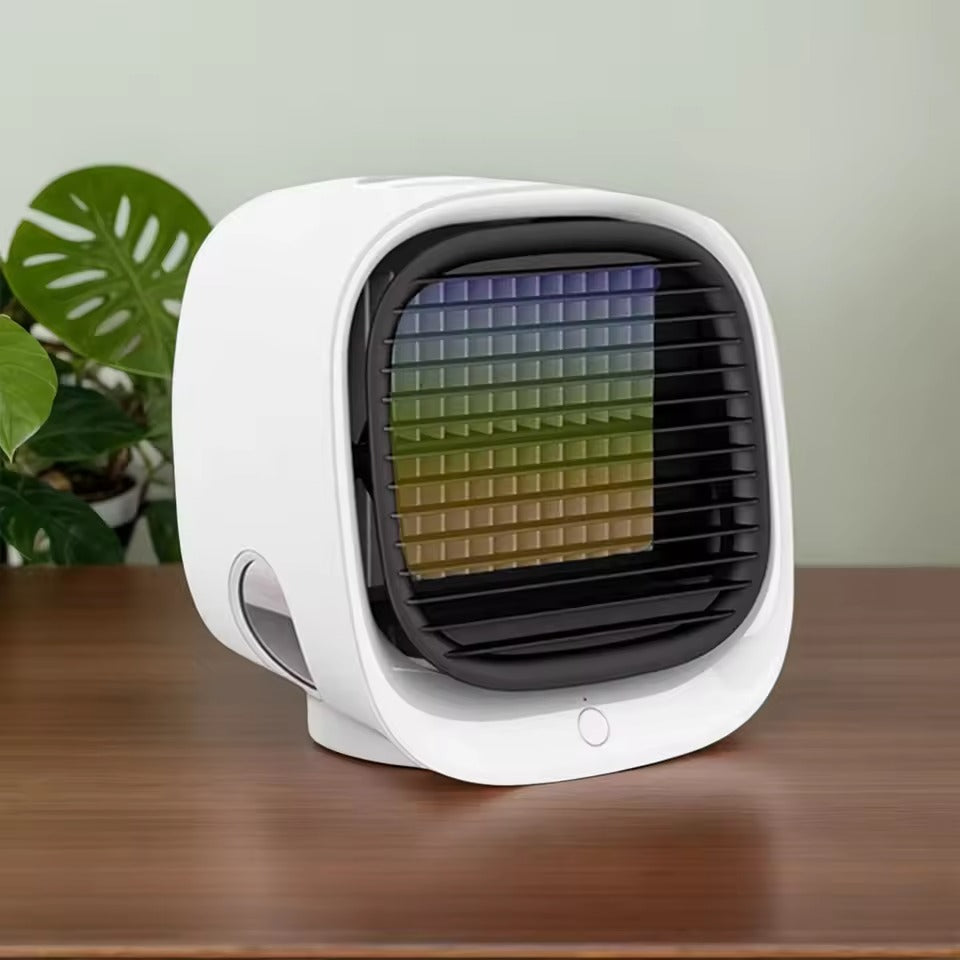White portable air conditioner on a wooden surface with a plant in the background