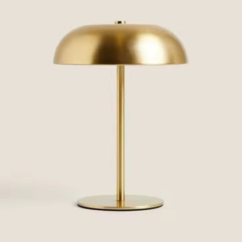 Gold table lamp on a beige background