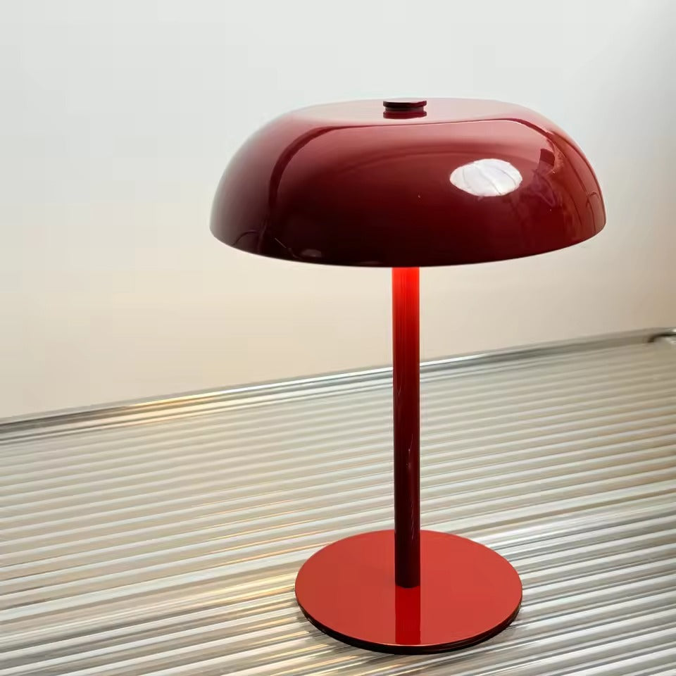Red table lamp with a minimalist design on a neutral background