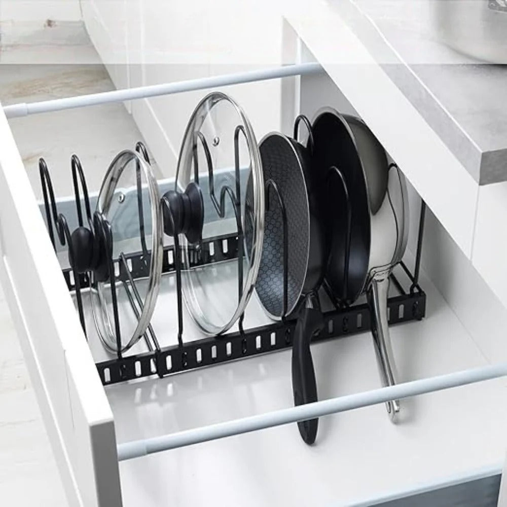 Kitchen cabinet with a pot and pan organizer holding lids and pans.