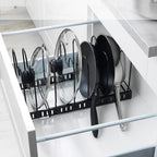 Kitchen cabinet with a pot and pan organizer holding lids and pans.