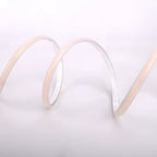 Close-up of a coiled white cable on a light gray background