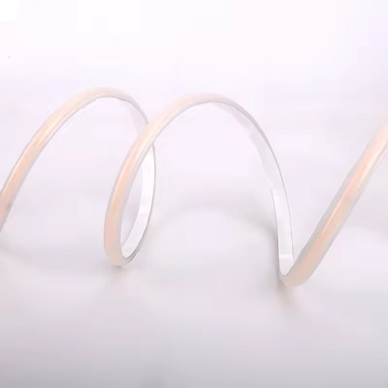 Close-up of a coiled white cable on a light gray background