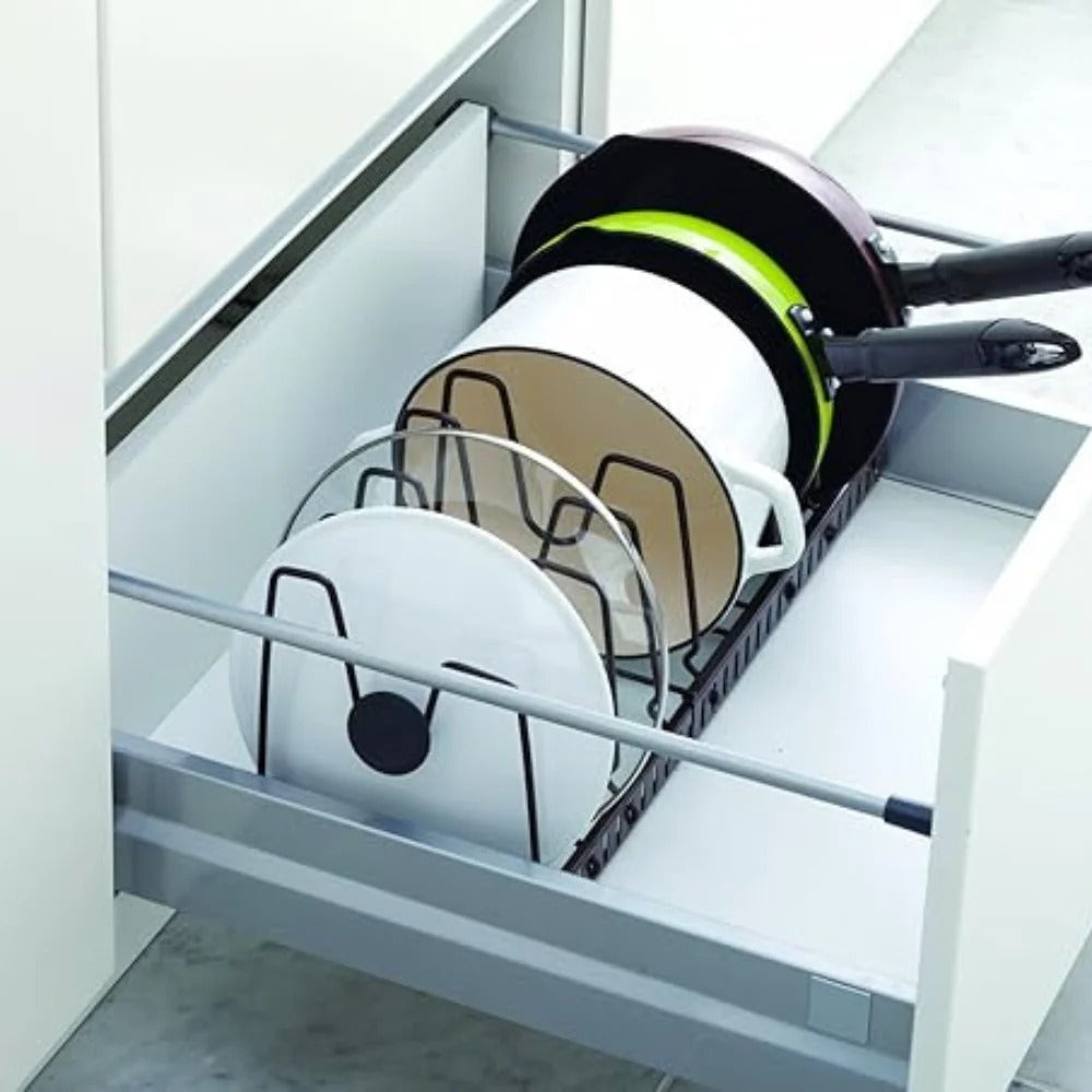 Pots and pans in a pull-out kitchen drawer organizer.