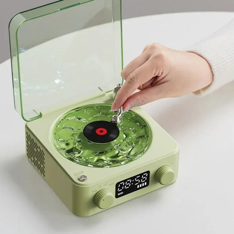Green record player with a hand placing a vinyl record on it, surrounded by images of nature-themed records.
