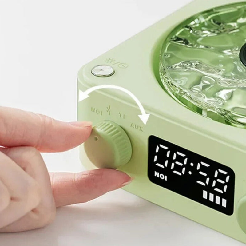 Green electronic device with digital display and control knobs on a white background