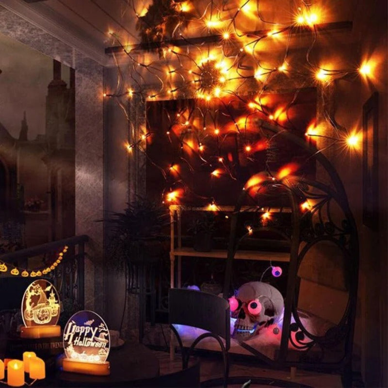 Decorative string lights on a wall with Halloween-themed decorations below.