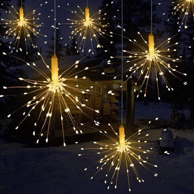 Decorative string lights resembling fireworks in a snowy outdoor setting.