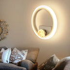 Decorative wall mirror with a light fixture in a living room setting.