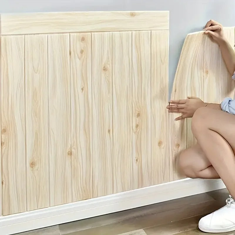 Person assembling a wooden headboard against a light blue wall.