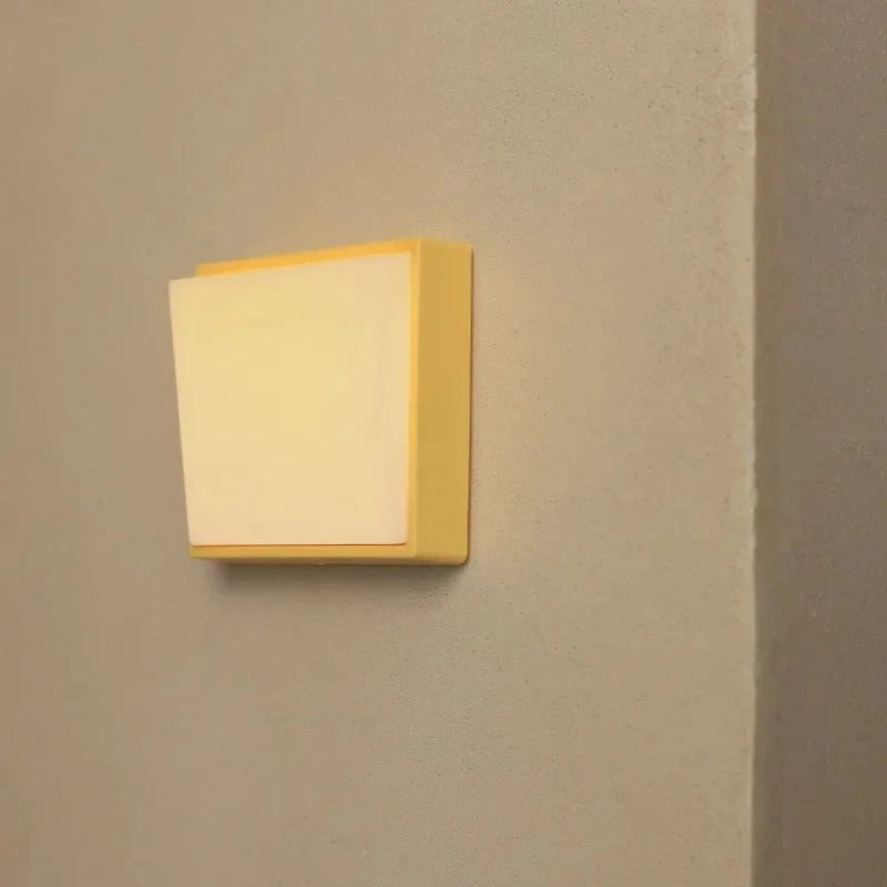 Square wall light fixture on a beige wall