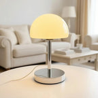 Table lamp with a yellow shade on a table in a living room setting