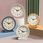 Four colorful clocks on a neutral background
