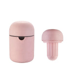 A light pink textured silicone travel toothbrush case shown in two views: one closed with a small black accent line, and one open showing the ribbed brush head insert.