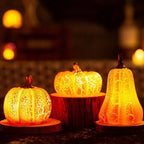 Three decorative pumpkins with a textured surface, glowing warmly against a blurred background.