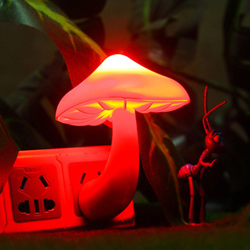 Mushroom-shaped lamp emitting a red glow with a blurred background
