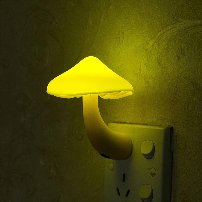 Mushroom-shaped lamp emitting a yellow glow with a wall background
