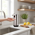 Hand using a soap dispenser on a kitchen counter with lemons and a cutting board.