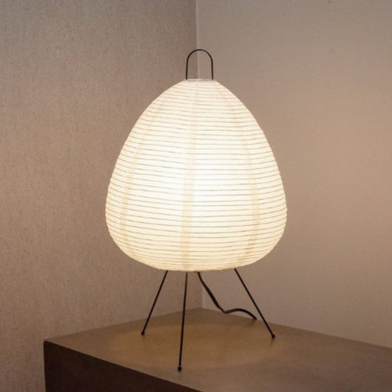 Modern table lamp with a white woven shade on a neutral background