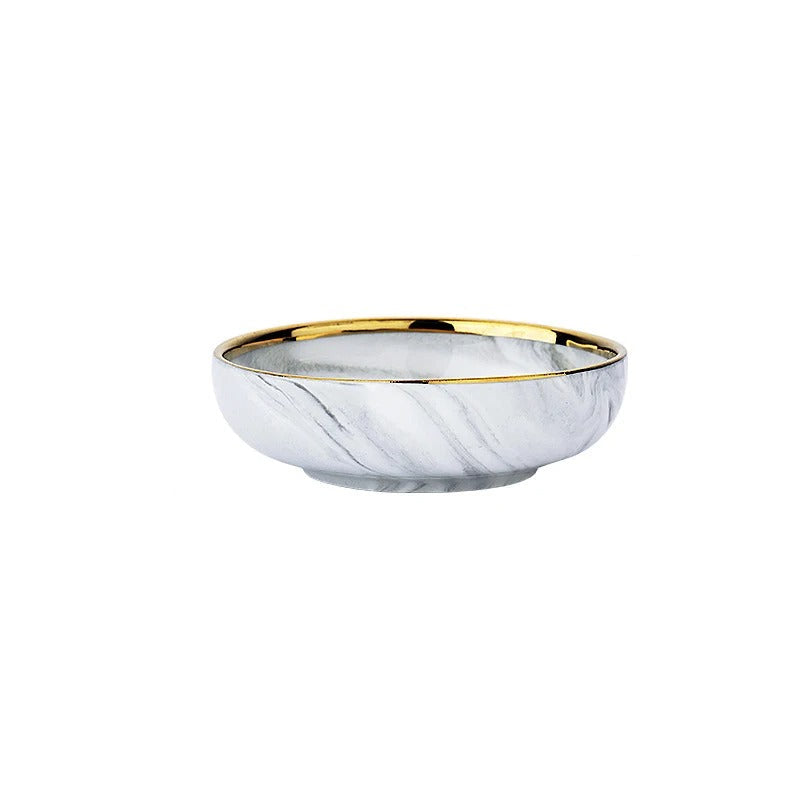 Marble-patterned saucer with gold rim and measurements on a white background