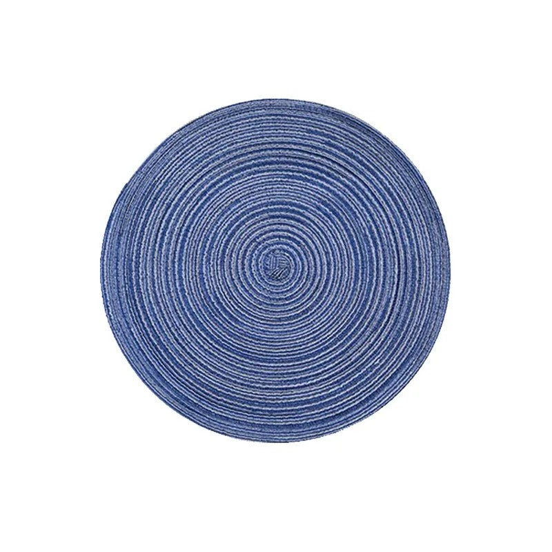 Round blue rug with concentric circle pattern on a white background