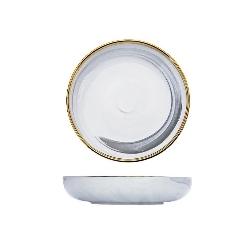 Ceramic plate with gold rim and measurements on a white background