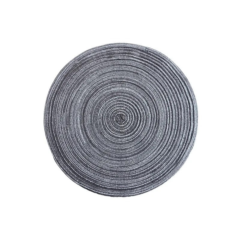 Round gray rug with concentric circle pattern on a white background